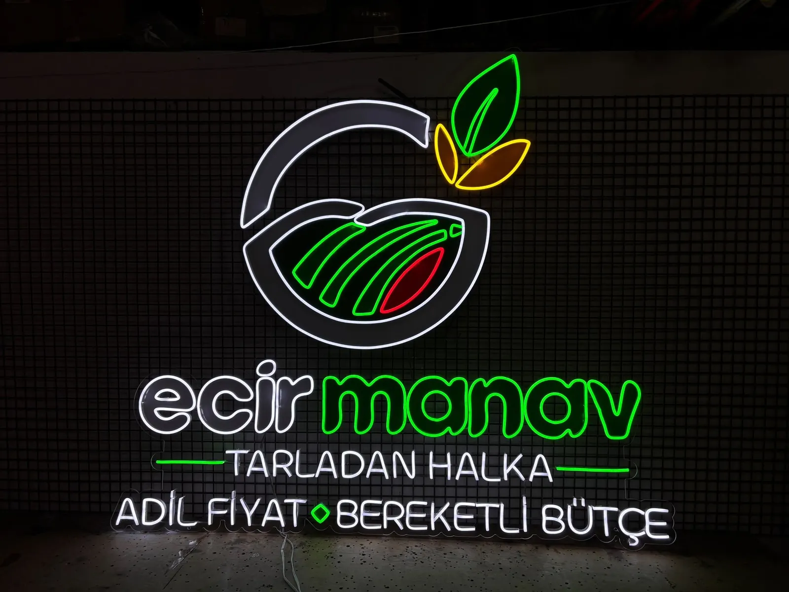 Green and white 'ecir manav' logo neon with leaves