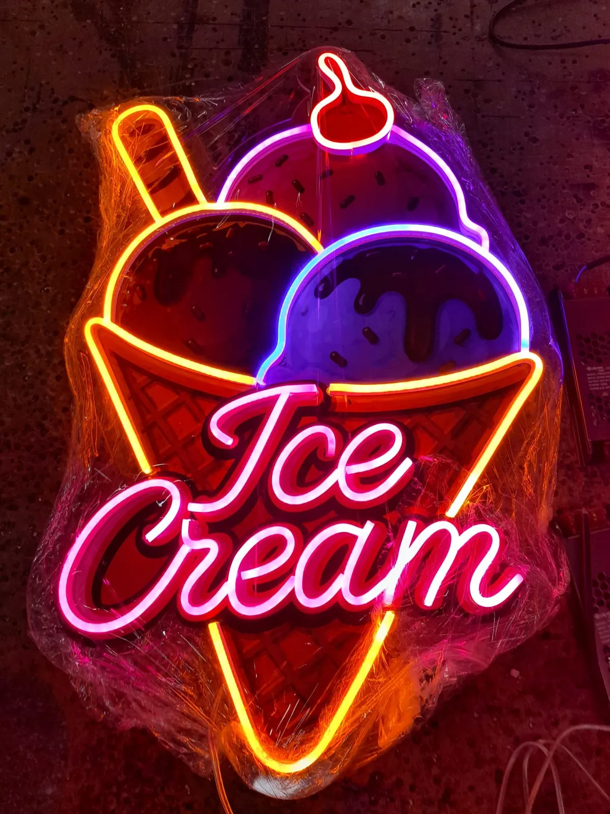 Pink 'Ice Cream' neon on a printed ice cream cone backboard
