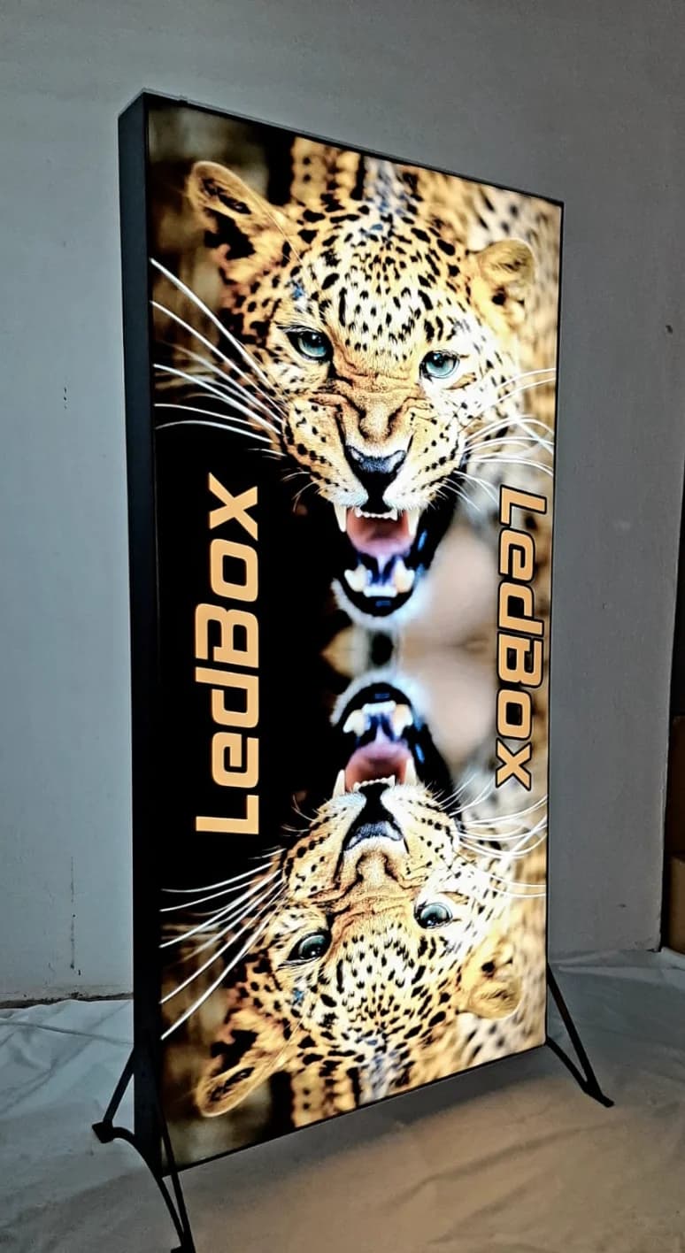 Backlit 'LedBox' lightbox with a mirrored leopard print in a black frame on legs